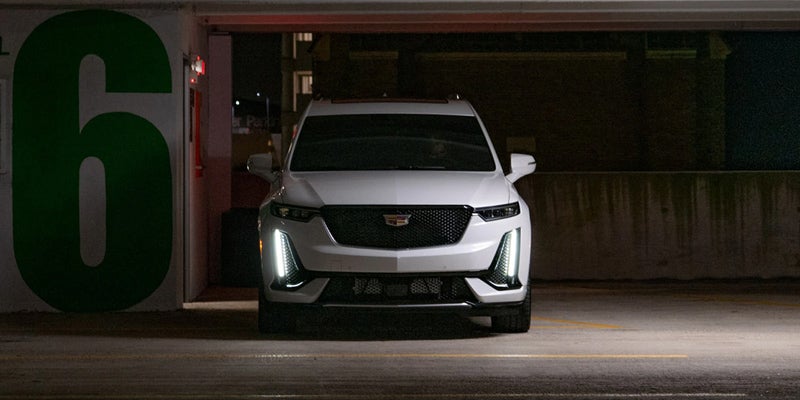 White Cadillac XT6 parked in the garage at night