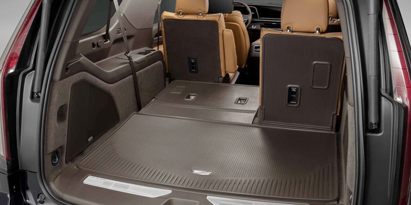 Interior design of a Cadillac Escalade-ESV putting down the seats and seeing how much space there is