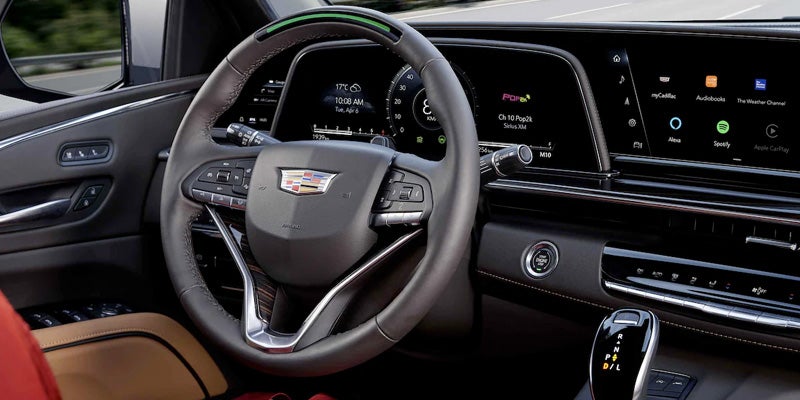 interior design of the steering wheel and center console of a Cadillac Escalade