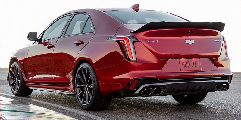 Red Cadillac CT4-V parked on the road when it's cloudy outside